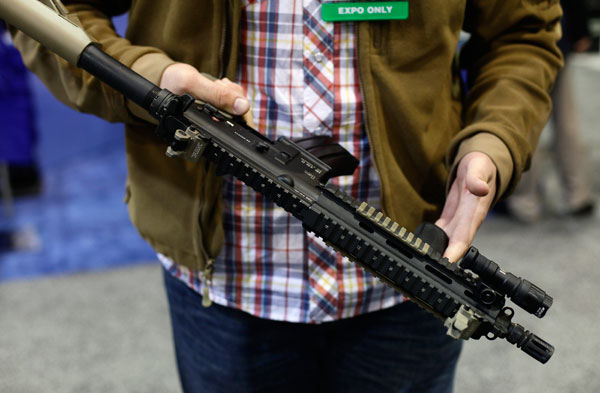 		<p>An attendee holds an assault style weapon at the 7th annual Border Security Expo in Phoenix, Arizona March 12, 2013. Products and services from over 100 companies are on display, showing the latest technology in security products and drawing law enfo