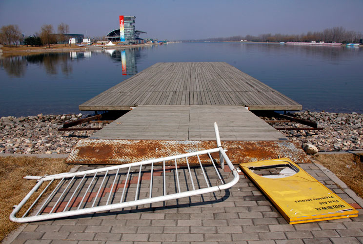 An old Olympic accreditation board lies on an unmaintained jetty at the deserted former venue for the 2008 Beijing Olympic Games rowing competition, located on the outskirts of Beijing March 27, 2012. The gigantic infrastructures built for the Beijing Oly