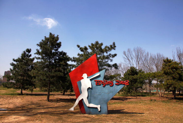 A sign stands at a deserted field showing where the stadium for the 2008 Olympic Games baseball competition once stood in central Beijing March 30, 2012. The gigantic infrastructures built for the Beijing Olympics, namely the "Bird's Nest", and the Nation