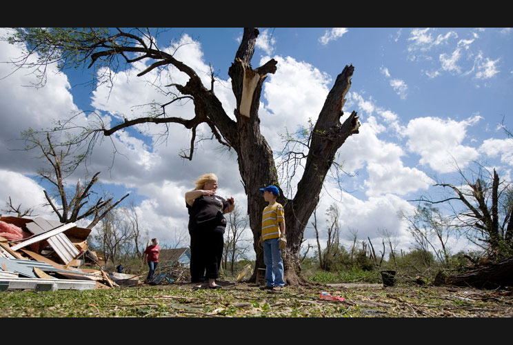 Sandy Umphreys describes her tornado experience to her 10-year-old relative, Bryan Pope. As of Sunday, rescue and clean-up efforts were underway across the Midwest.