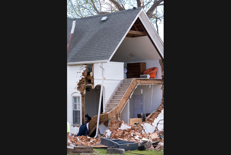 A view of a home after part of its exterior was destroyed when a tornado hit the town.