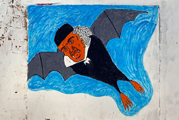 		<p>Vampire bat Gaddafi flies high and free on this wall painting.</p>