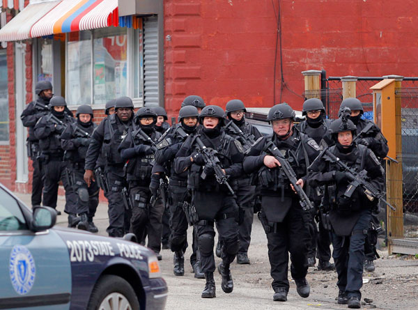 		<p>SWAT teams enter a suburban neighborhood to search an apartment for the remaining suspect in the Boston Marathon bombings in Watertown, Massachusetts April 19, 2013. Police killed one suspect in the Boston Marathon bombing during a shootout and were 