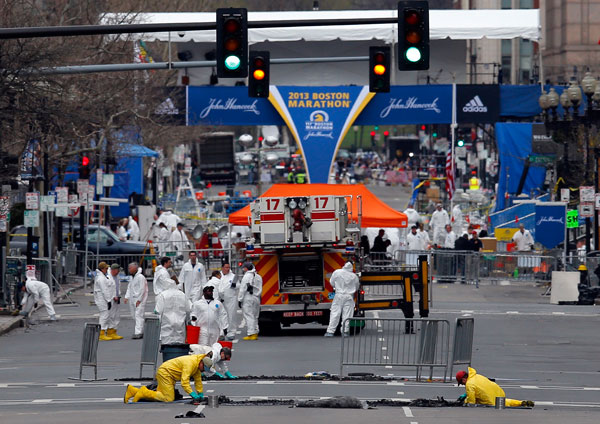 		<p>Investigators look for evidence on Boylston Street at the scene of the Boston Marathon bombings in Boston, Massachusetts April 18, 2013. Two explosions hit the Boston Marathon as runners crossed the finish line on killing at least three people and in