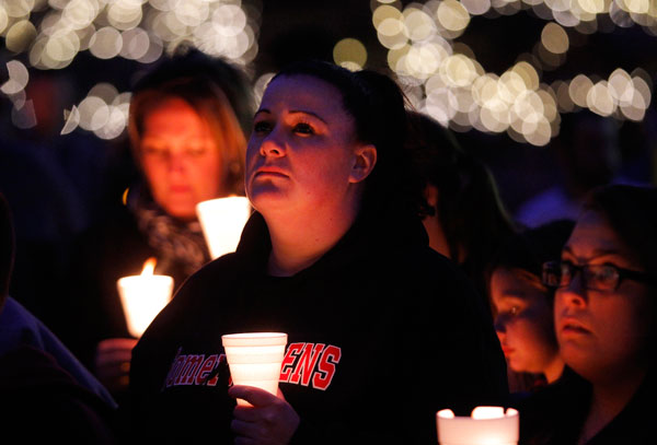 		<p>Women hold candles as they listen to a speaker during a candlelight vigil for the victims of the Boston Marathon bombings, in Somerville, Massachusetts, April 18, 2013. Investigators released pictures of two suspects in the Boston Marathon bombing on