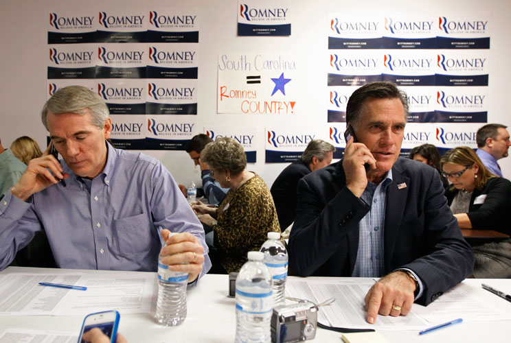 U.S. Republican presidential candidate and former Massachusetts Governor Mitt Romney and Senator Rob Portman (R-OH) call potential voters from his campaign headquarters in Charleston, South Carolina, January 19, 2012. 