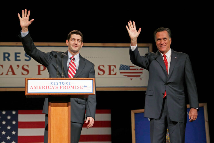 House Budget Chairman Paul Ryan (L) (R-WI) introduces U.S. Republican presidential candidate Mitt Romney (R) as he addresses supporters at Lawrence University during a campaign stop in Appleton, Wisconsin, March 30, 2012. 