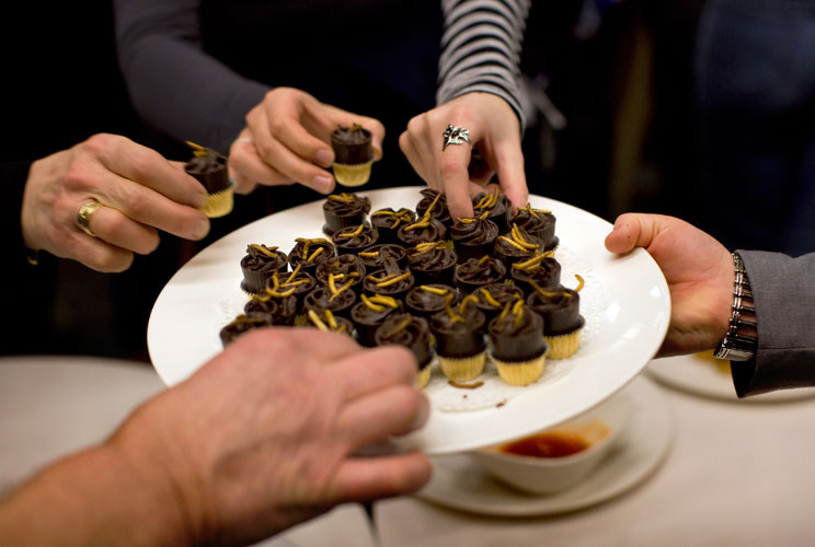 People try an insect snack (meal worm pralines) during a break in the lecture given by Professor Arnold van Huis at the University of Wageningen January 12, 2011. 