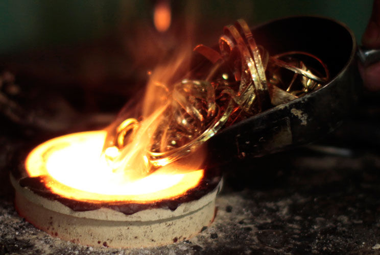 A man melts down gold jewellery in Los Angeles, California August 23, 2011. At that time gold prices retreated in choppy trade after earlier hitting record highs as a recovery in appetite for assets seen as higher risk, such as stocks, took the steam out 