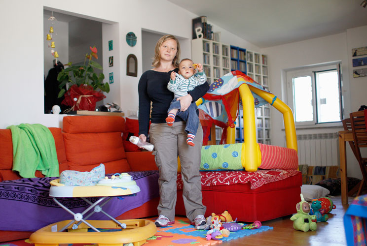 Francesca Baldi, 32, poses for a picture as she takes care of a seven month-old baby in a private household in Rome May 11, 2012. Baldi studied for five years at university in Pisa where she received a degree and a doctorate in literature and philosophy. 