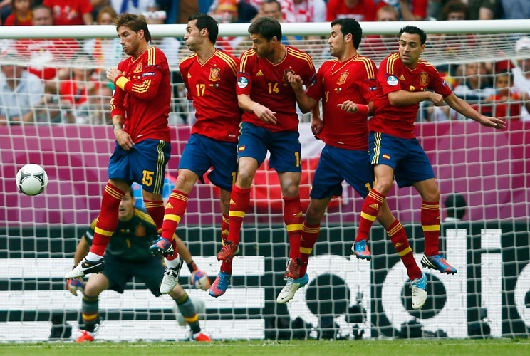 Spain's Sergio Ramos, Alvaro Arbeloa, Xabi Alonso, Sergio Busquets and Xavi Hernandez (L-R) form a defensive wall as Italy's Andrea Pirlo (not pictured) takes a free kick during their Group C Euro 2012 soccer match at the city stadium in Gdansk, June 10, 