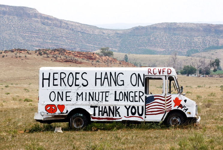 A message is painted on a truck near where the High Park fire has burned out, west of Fort Collins, in Colorado, June 18. The fire has charred more than 85 square miles (200 square km) and sent a plume of smoke billowing thousands of feet into the air. Th