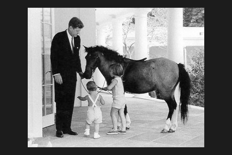 President John F. Kennedy (1961-63) spends some time at the White House with his children, Caroline and John Jr., and their pony, Macaroni. January 19, 2009.