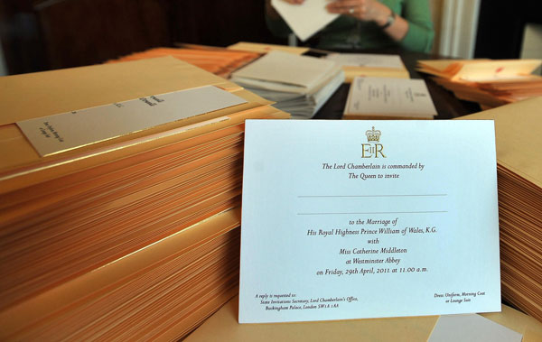 		<p>A member of the Lord Chamberlain's Office at Buckingham Palace inserts invitations, for William and Kate's wedding, into envelopes in London February 16, 2011. Queen Elizabeth sent out nearly 2,000 gold-embossed invitations for the wedding.</p>