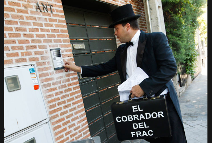 Francisco of the Spanish company El Cobrador del Frac (The Debt Collector in Top Hat and Tails) rings the doorbell of a house in Pozuelo de Alarcon, outside Madrid July 4, 2012. The company specialises in sending men dressed in tailcoats to make debtors p