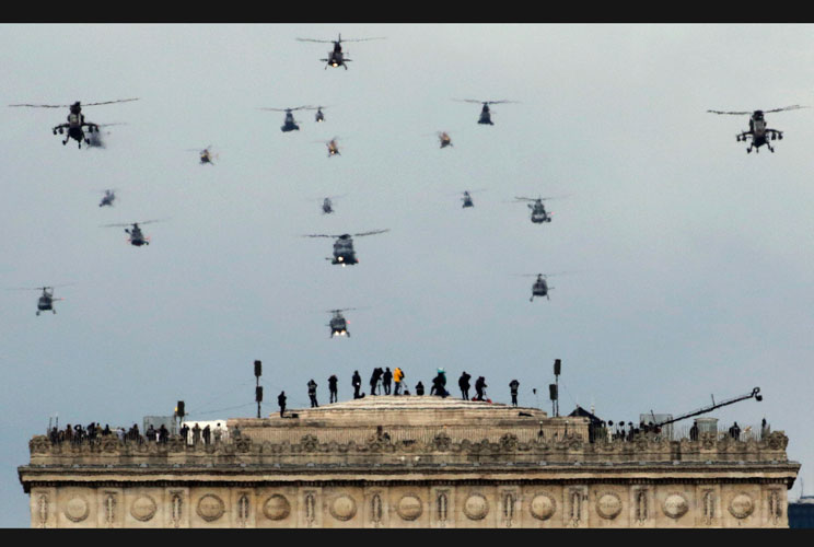 A formation of military helicopters fly over the Arc de Triomphe during the traditional Bastille Day military parade in Paris July 14, 2012.  