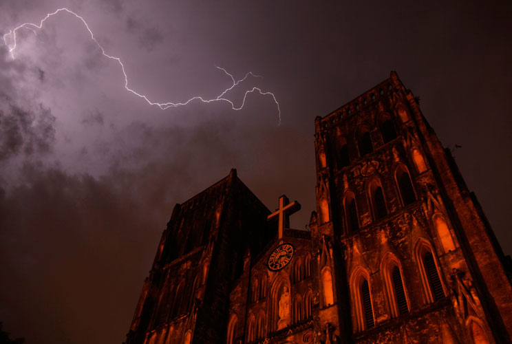 Lighting strikes over Saint Joseph cathedral during a storm in Hanoi July 14, 2012. 