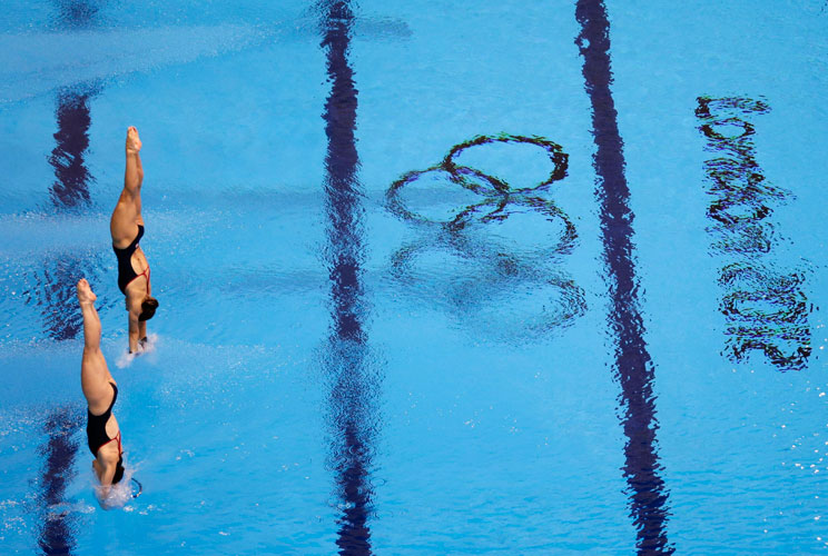 Syncronised divers from team GB attend a training session at the main pool of the Aquatics Centre before the start of the London 2012 Olympic Games in London July 25, 2012.       