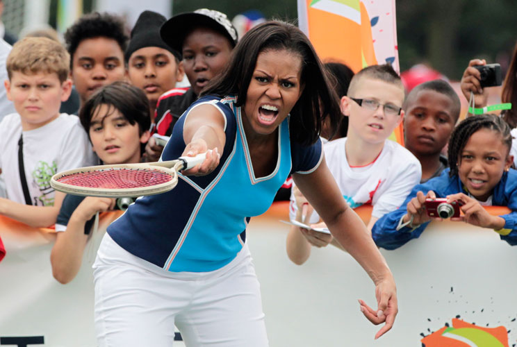 U.S. first lady Michelle Obama plays tennis during an event for U.S. military children and British and U.S. students at the U.S. embassy in central London July 27, 2012.  