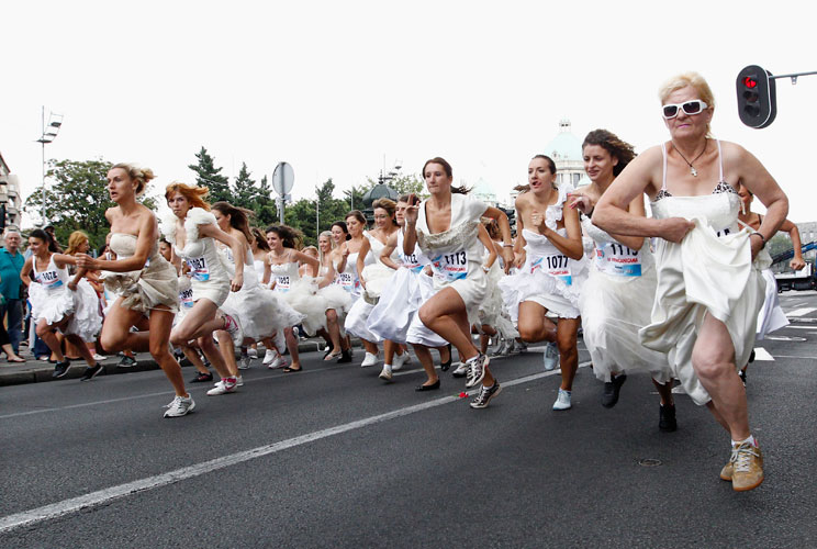 Women dressed in bridal gowns sprint during the annual "Bridal race" in central Belgrade July 22, 2012. The winner and two runners-up receive numerous awards including the wedding gown they had chosen to race in.   