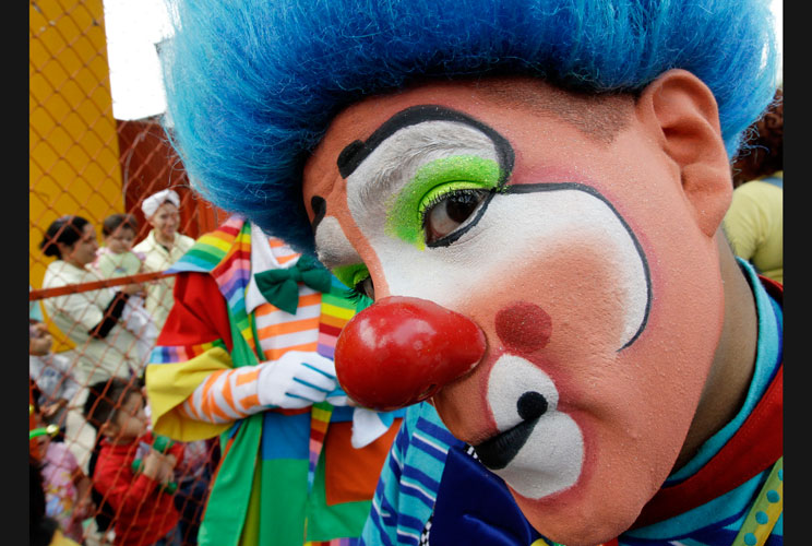 A clown takes part in an annual pilgrimage along a street at the Basilica of Guadalupe in Mexico City July 18, 2012. Hundreds of clowns took part in the annual event to thank the Virgin of Guadalupe for helping them find work through the year, according t