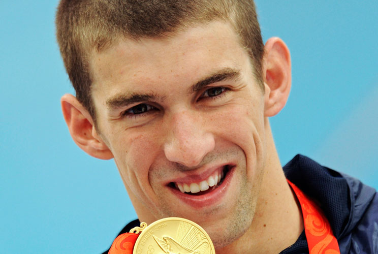 MICHAEL PHELPS GOLD MEDAL - 4th of 8Michael Phelps of the U.S holds his gold medal after winning the men's 200 meters butterfly swimming final at the National Aquatics Center during the Beijing 2008 Olympic Games August 13, 2008. Phelps swam his way into 