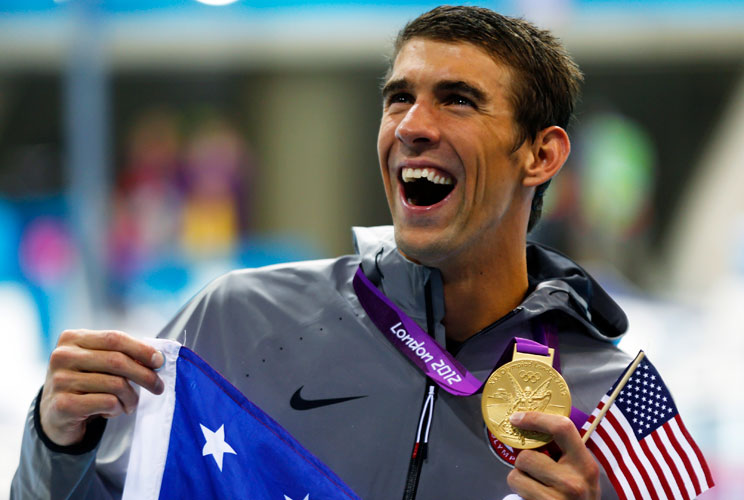 Michael Phelps of the U.S. holds his 19th Olympic medal presented to him in the men's 4x200m freestyle relay victory ceremony during the London 2012 Olympic Games at the Aquatics Centre July 31, 2012.