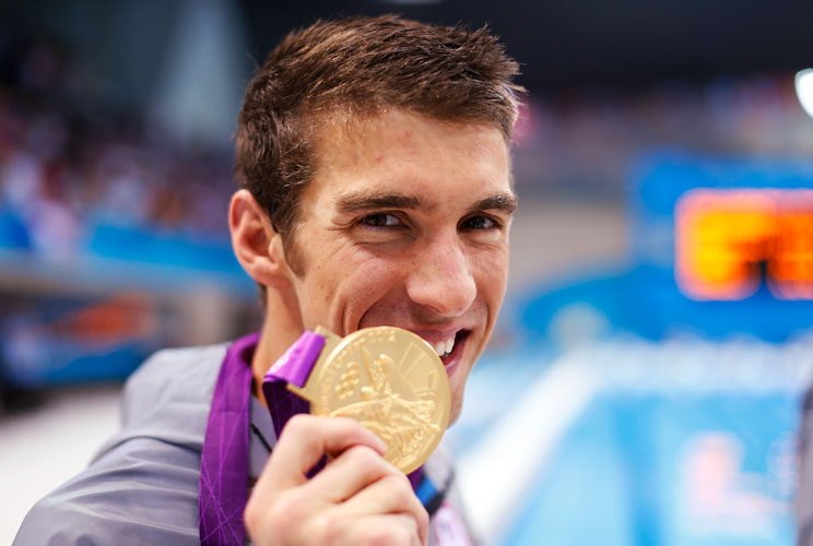 Michael Phelps of the U.S. poses with his gold medal after winning the men's 4x100m medley relay final during the London 2012 Olympic Games at the Aquatics Centre August 4, 2012. Phelps ended his incredible Olympic career on the perfect note on Saturday, 