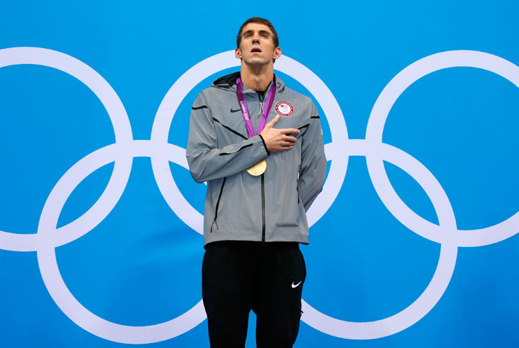 Gold medallist Michael Phelps of the U.S. listens to his national anthem during the men's 200m individual medley victory ceremony during the London 2012 Olympic Games at the Aquatics Centre August 2, 2012.