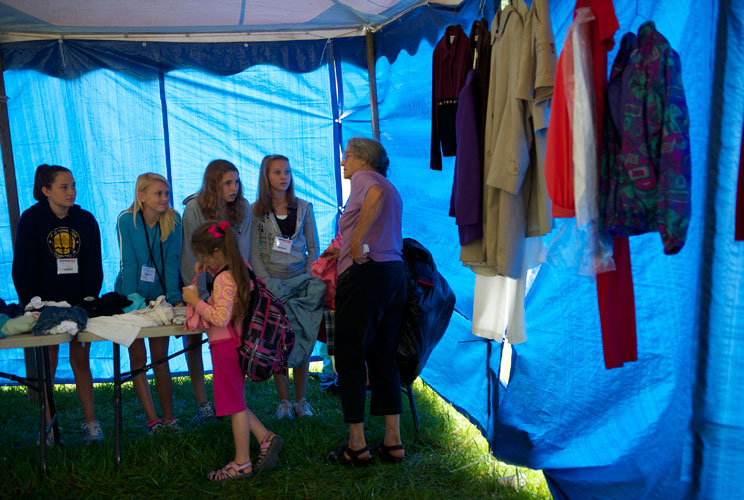 Girls help to distribute free clothes at the clinic. 