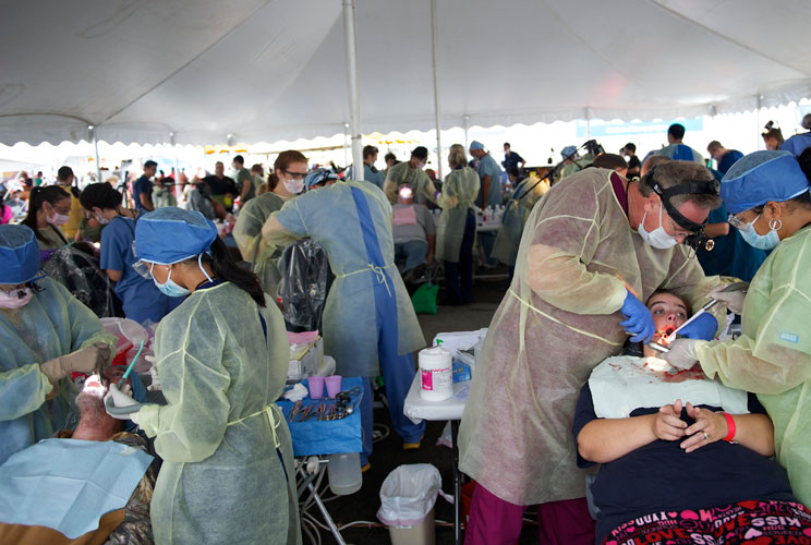 Dentists work on patients at the clinic. 