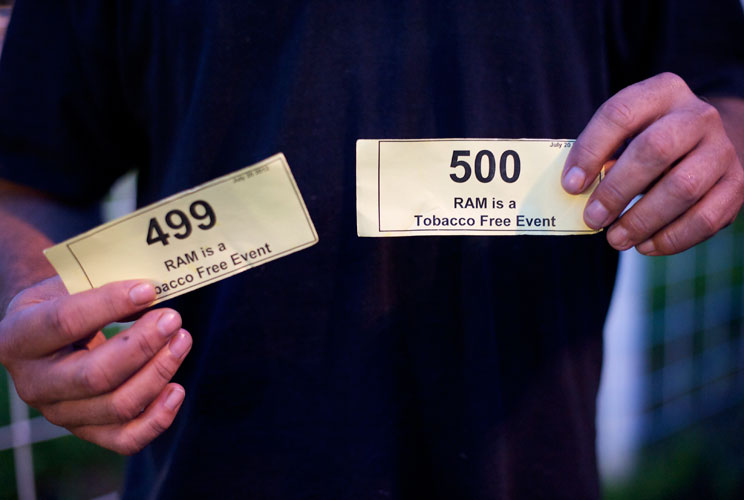 A patient displays his place numbers for treatment after entering the clinic. 