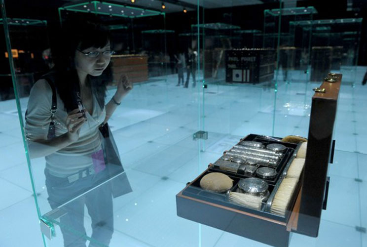 A Chinese woman looks at items on display at a Louis Vuitton exhibition in Beijing. French labels are the most sought-after luxury products for Chinese shoppers, a survey showed, as a booming economy creates a growing legion of newly affluent consumers.