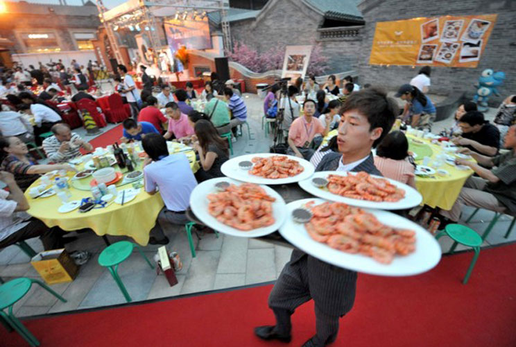 People gather at a gourmet festival to experience Taiwanese food in Beijing. Gross domestic product in the world's second-largest economy grew 9.5 percent year-on-year in the second quarter, the National Bureau of Statistics said.