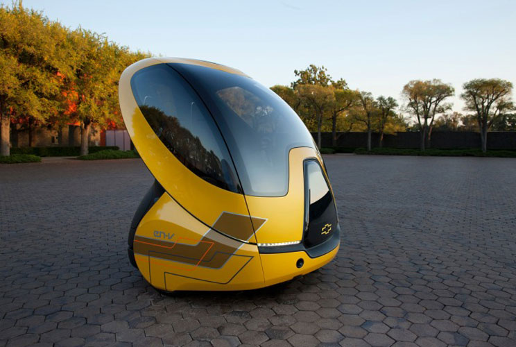 General Motors' goal for this vehicle is to be a connected, zero-emissions personal transportation car that addresses issues with traffic congestion, parking availability, air quality and affordability. At 1,100 pounds and less than 50 inches long, it's o