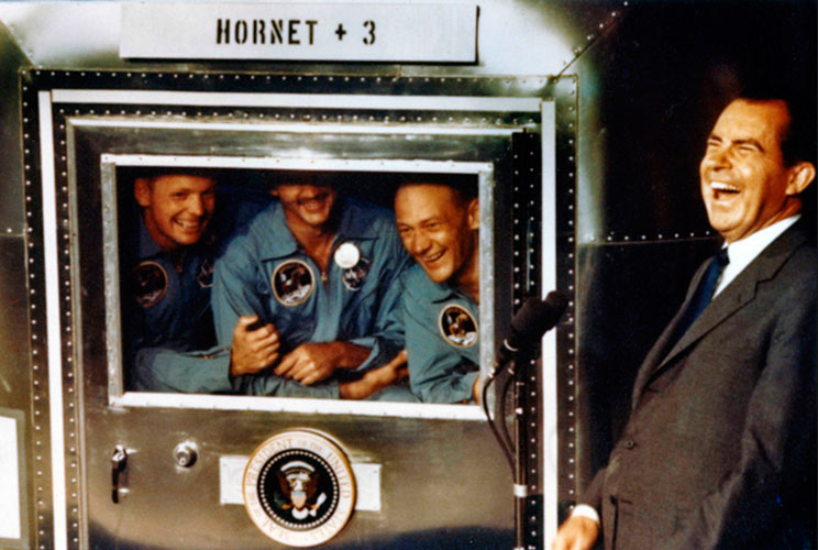 		<p>The Apollo 11 astronauts Armstrong (left), Collins (center), and Aldrin share a laugh with President Richard Nixon in their isolation unit aboard the USS Hornet after their triumphant splashdown in the Pacific. The President was on hand to greet the 