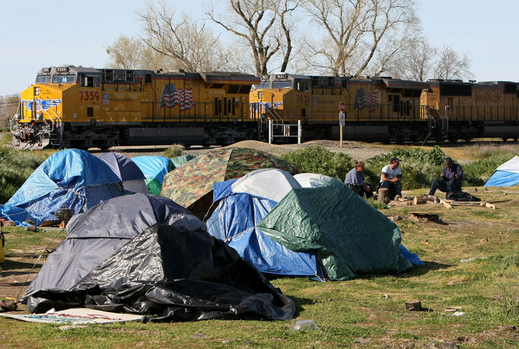 Just beyond the glitz and bright lights of the casinos in Reno, Nevada, another stark reality exists.  What started with a few tents down by the train track in 2008, quickly doubled and then tripled, and within weeks the number homeless people living in t