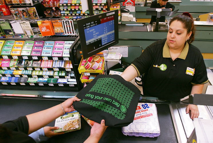 SuperValu, which uses 1.5 billion bags a year at its grocery stores, is retraining its cashiers and baggers to eliminate double-bagging, put more items in each bag and eliminate bags entirely for gallon jugs of milk and other things with handles. Customer