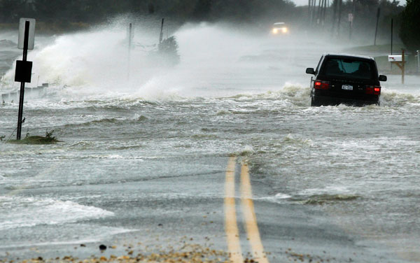 		<p>A car drives through water driven onto a roadway by Hurricane Sandy in Southampton, New York, October 29, 2012. Hurricane Sandy, the monster storm bearing down on the East Coast, strengthened on Monday after hundreds of thousands moved to higher grou