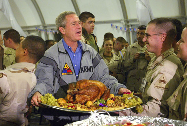 		<p class="p1">U.S. President George W. Bush carries a platter of turkey and fixings as he visits U.S. troops for Thanksgiving at Baghdad International Airport, November 27, 2003. Bush secretly traveled to Baghdad and paid the surprise Thanksgiving Day v