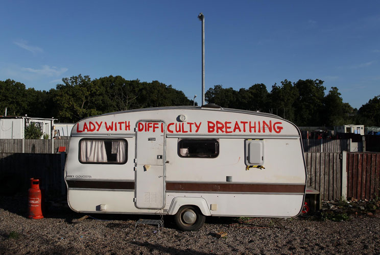 A resident's caravan painted with a slogan explaining a medical condition sits on a plot at Dale Farm travellers camp on September 19, 2011 in Basildon, England. Eviction of 80 traveller famillies is to begin after a 10 year legal battle to clear the site