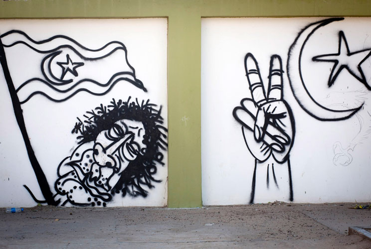 Graffiti is seen on a wall mocking disposed leader Muammar Gaddafi on October 18, 2011 in Benghazi, Libya.  