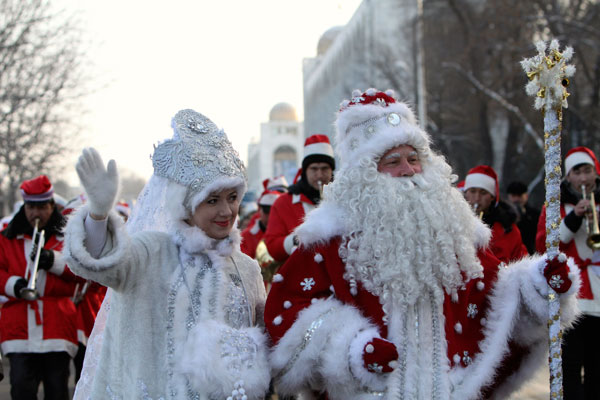 		<p>A man who is dressed up as Father Frost, the local equivalent of Santa Claus, and his "granddaughter" Snegurochka (Snow Maiden) greet passers-by during a New Year's Day parade in Bishkek.</p>