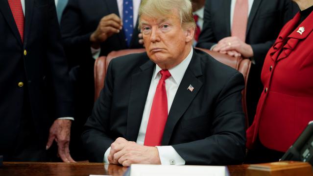 U.S. President Trump listens to reporters during bill signing ceremony in the Oval Office of the White House in Washington