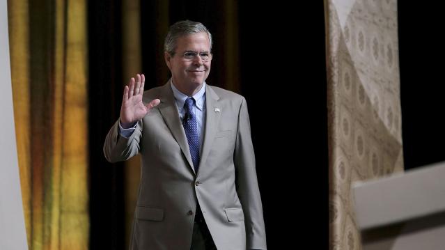 Republican presidential candidate Jeb Bush waves as he arrives to address a legislative luncheon held as part of the "Road to Majority" conference in Washington