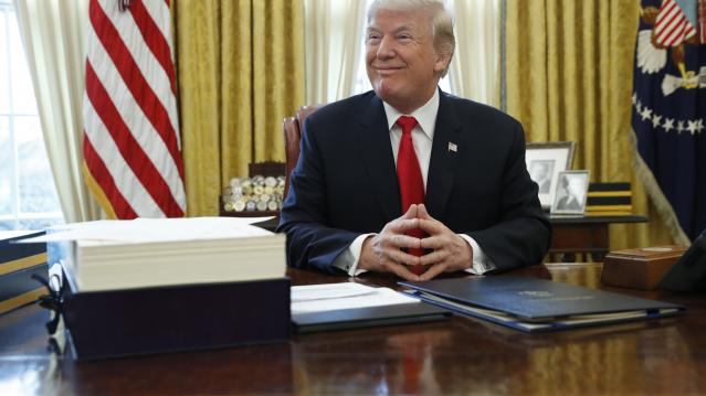 U.S. President Trump sits at his desk before signing bills at the White House in Washington