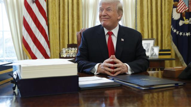 U.S. President Trump sits at his desk before signing bills at the White House in Washington