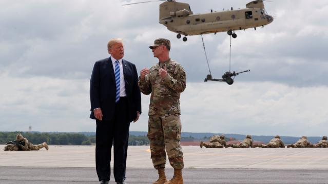 U.S. President Trump talks with U.S. Army Major General Piatt during demonstration at Fort Drum, New York