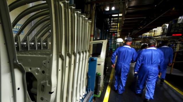 FILE PHOTO: People walk past a rack of SUV doors on a cart, at the General Motors Assembly Plant in Arlington, Texas June 9, 2015.  REUTERS/Mike Stone	