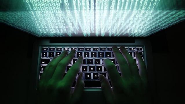 A man types on a computer keyboard in Warsaw in this February 28, 2013 illustration file picture. One of the largest ever cyber attacks is slowing global internet services after an organisation blocking "spam" content became a target, with some experts s